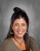 School photo of a female teacher with dark brown hair.