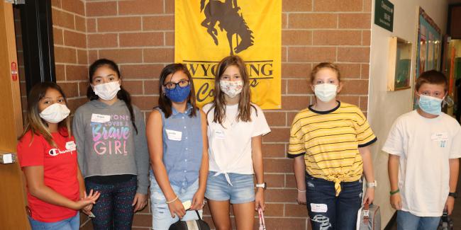 Students standing with masks on in a school