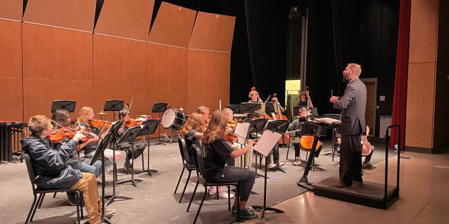Orchestra students are in the music theater at Wellington Middle/High School to play for the Music Festival